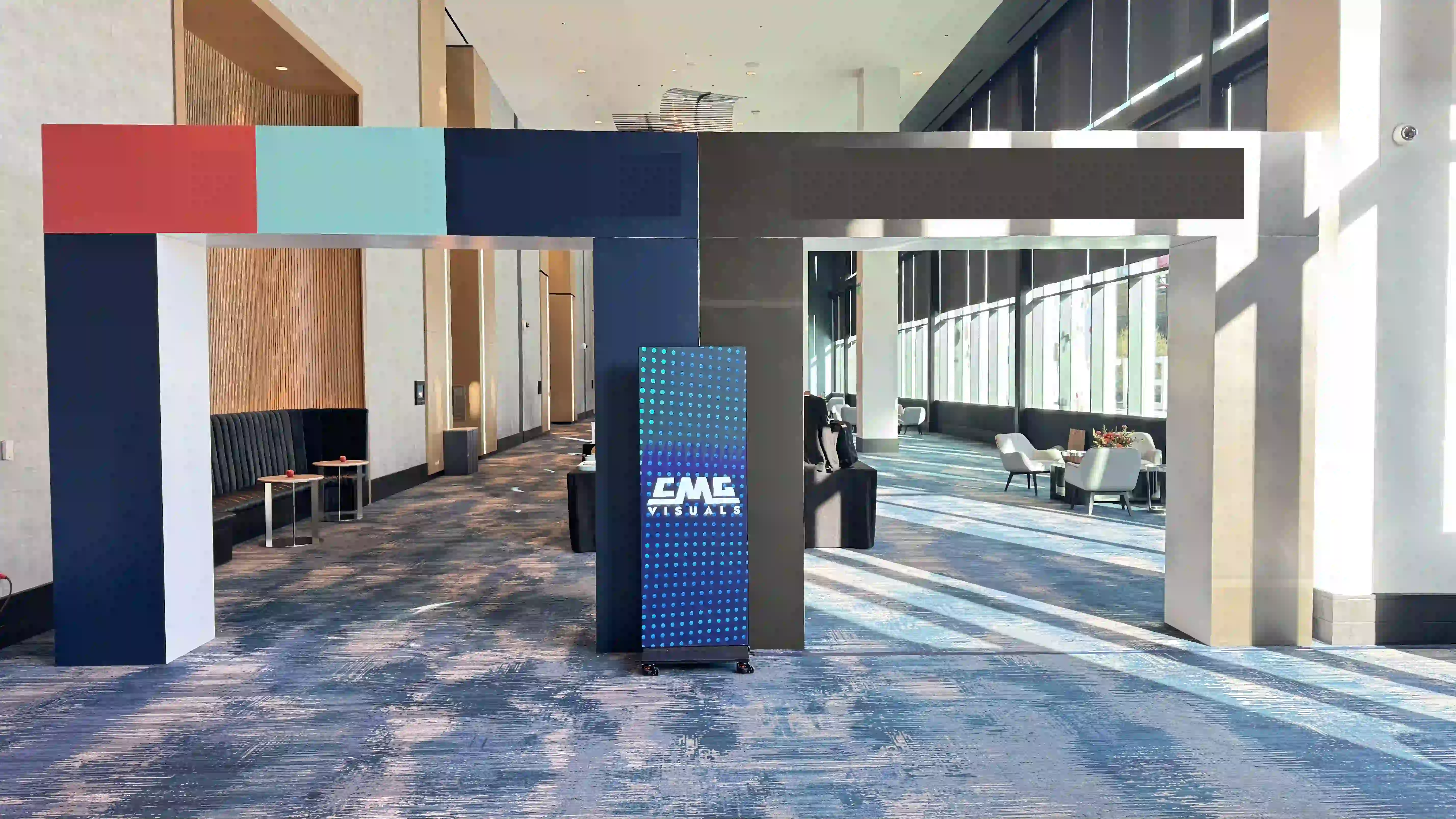 Single LED Video Wall poster that is in between two arches that displays the CMG Visuals logo on a static background.