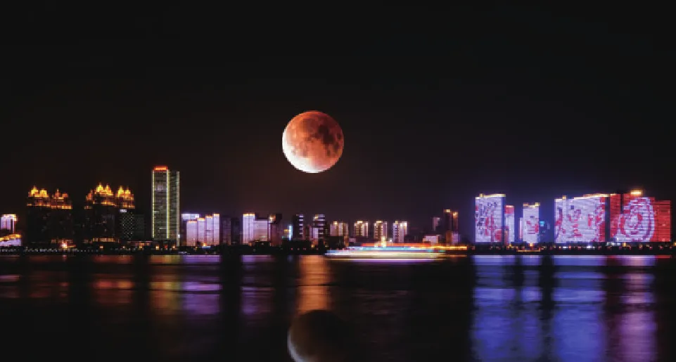 The same night cityscape with a lunar eclipse on a CMG Visuals 1609E panel, with shadow detail preserved at low brightness