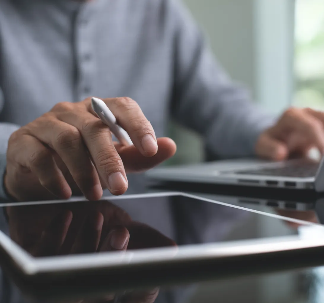 Person reviewing an agent's work on a tablet with a stylus