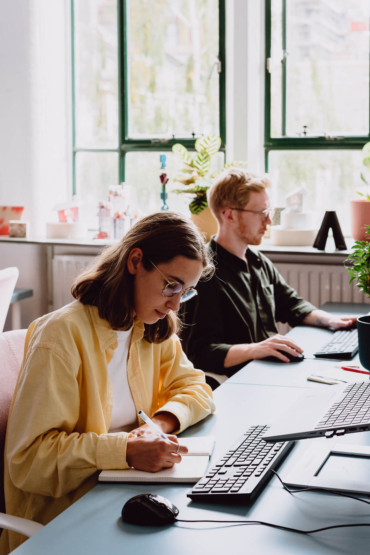 Photo of Malin, an associate architect, and her colleague taking notes in the studio. By Office S&M, RIBA Chartered Architectural Practice in London.