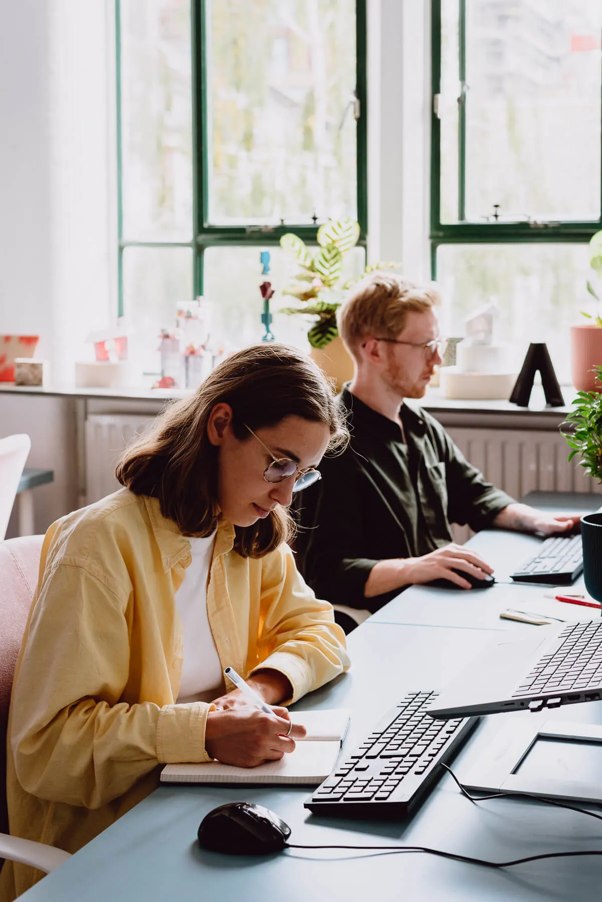 Photo of Malin, an associate architect, and her colleague taking notes in the studio. By Office S&M, RIBA Chartered Architectural Practice in London.