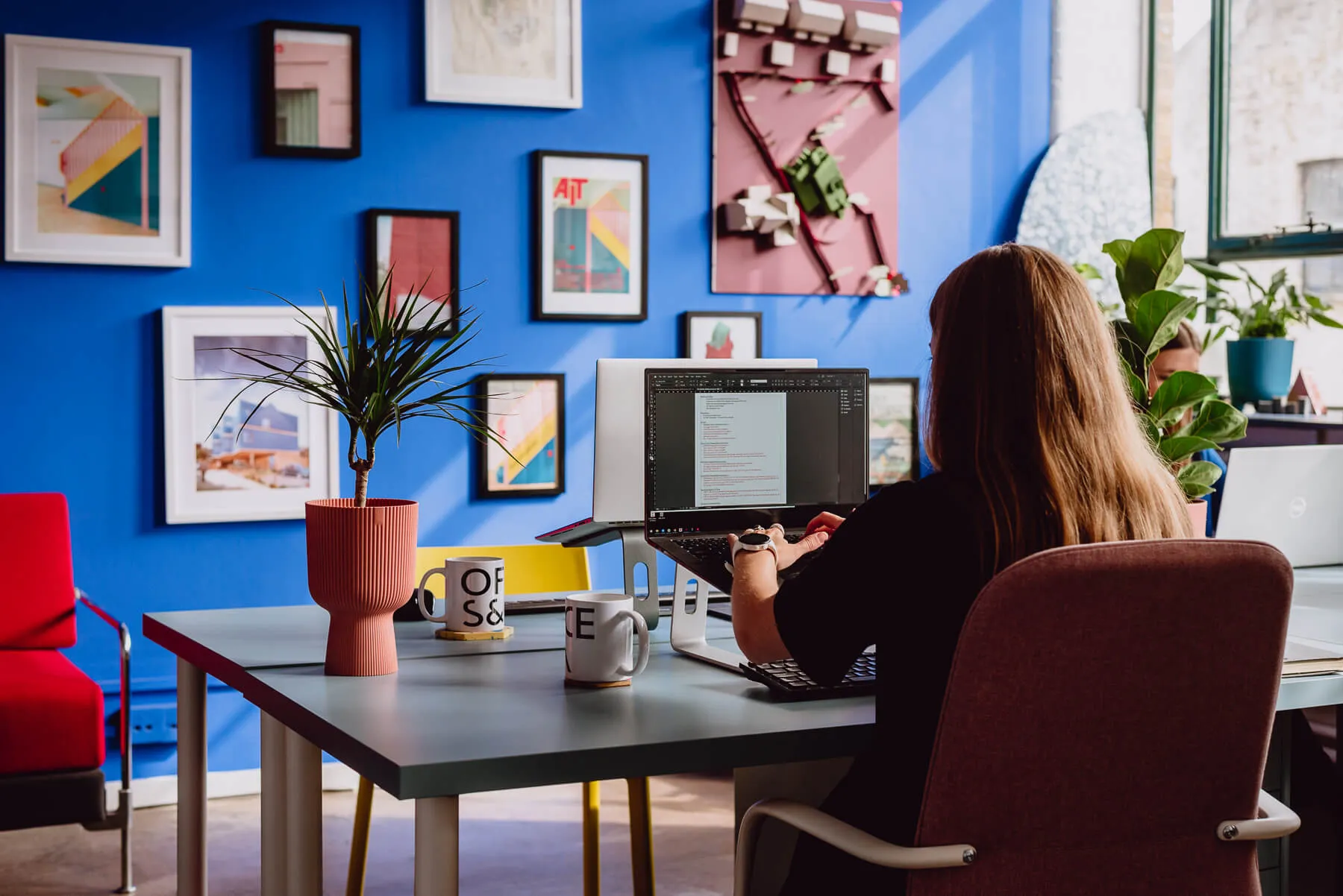Photo of Catrina, one of the directors of Office S&M, working in the studio. By Office S&M, RIBA Chartered Architectural Practice in London.
