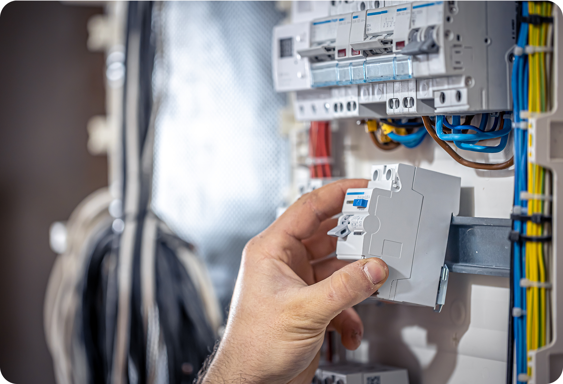 Person installing a modular electrical device in a distribution panel.