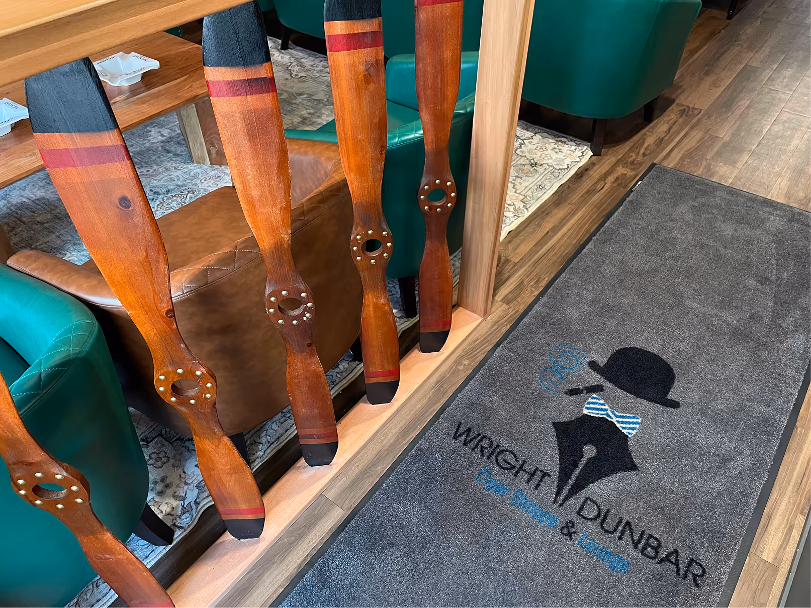 Wright Dunbar Cigar Lounge entrance rug (w logo) and bannister with antique plane propellers