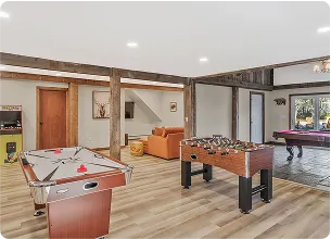 An Image of a Rustic game room with indoor games, such as foosball.