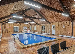 An Image of a Wooden cabin with a built-in indoor pool