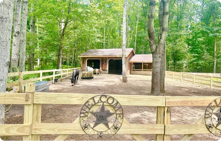 An image of a barn and fenced enclosure.