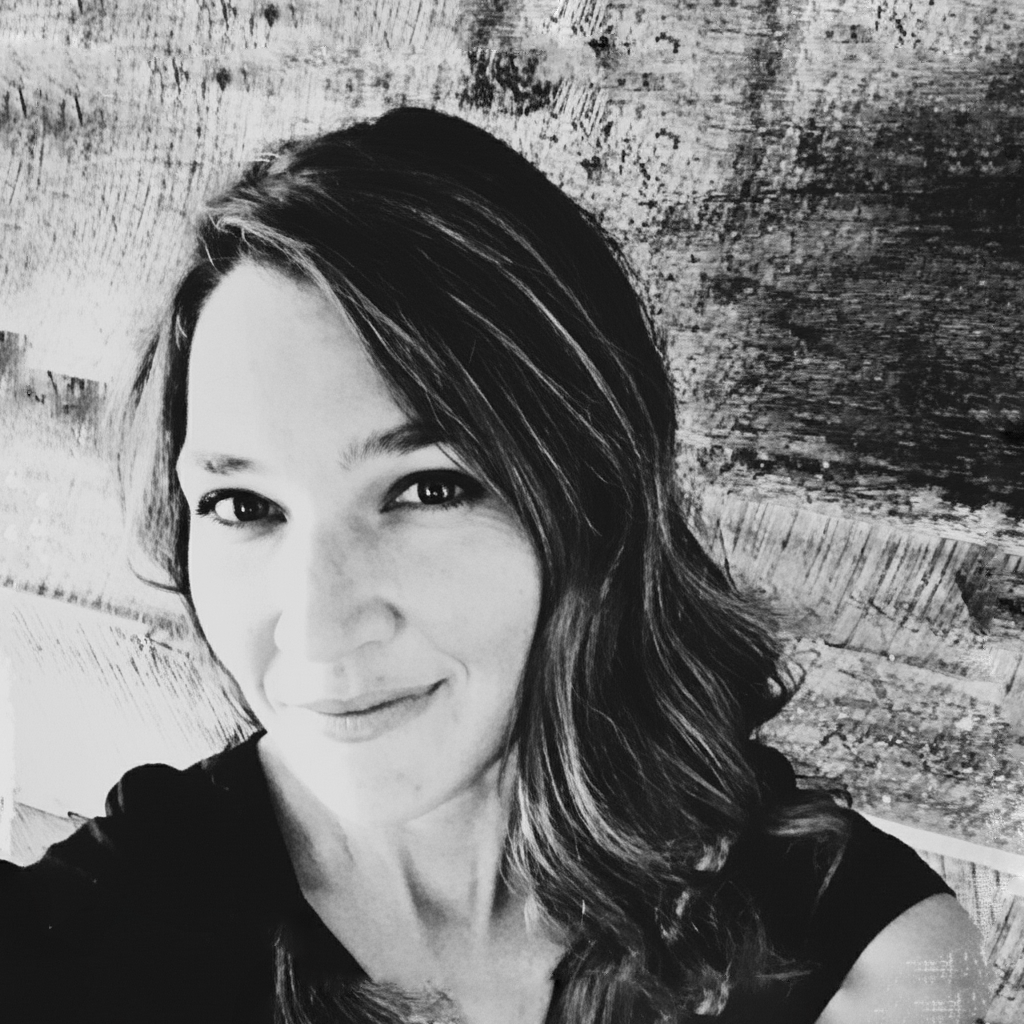 A woman with brown hair and a black shirt.