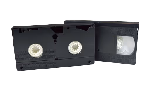 Two black VHS tapes with white labels.