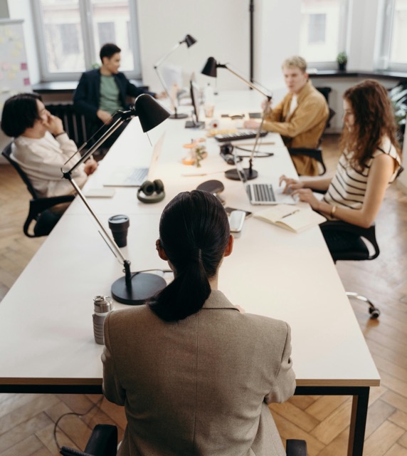 Business leader sitting at head off table