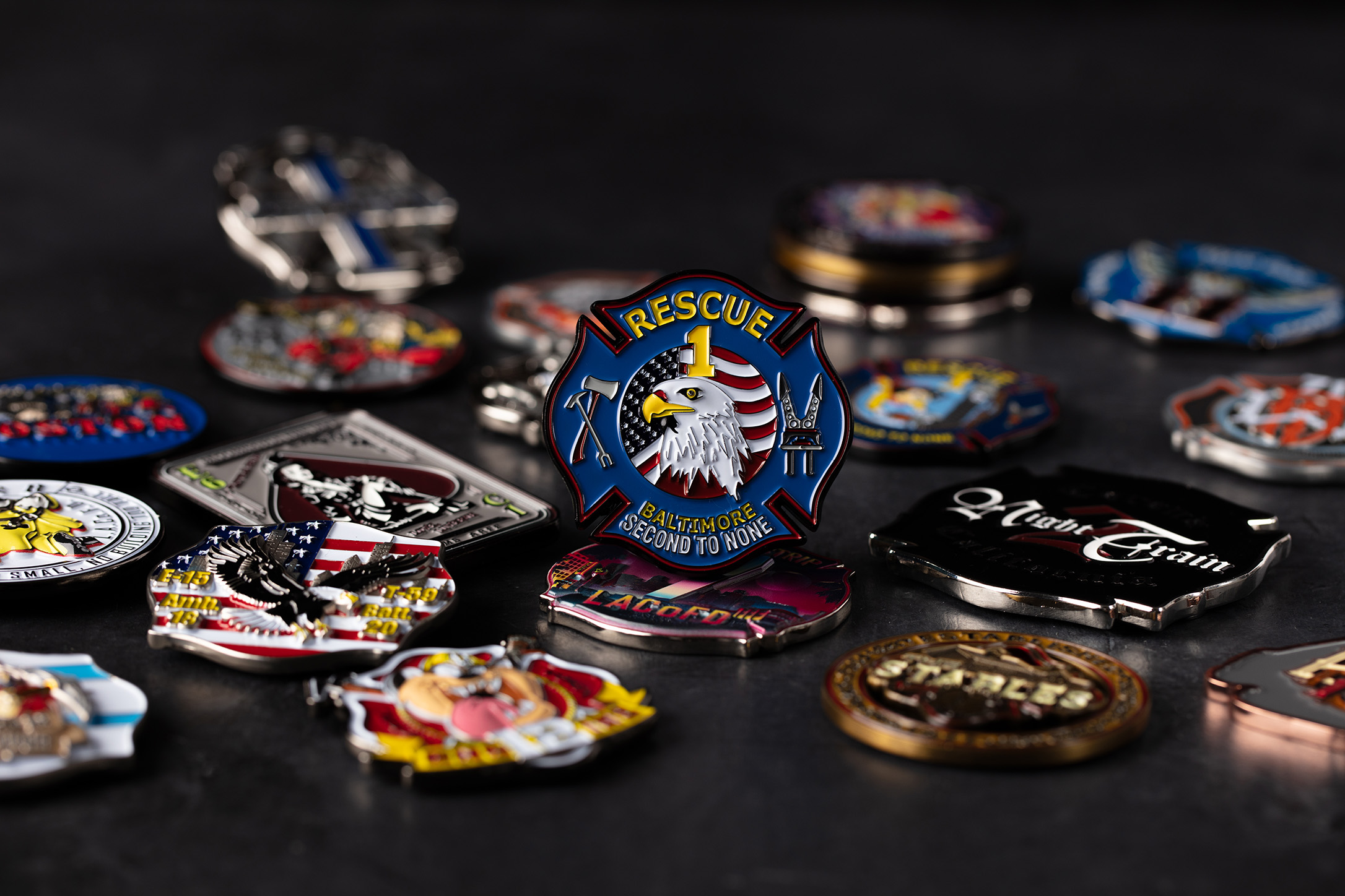 A pile of custom challenge coins with, focussed on a coin with an eagle