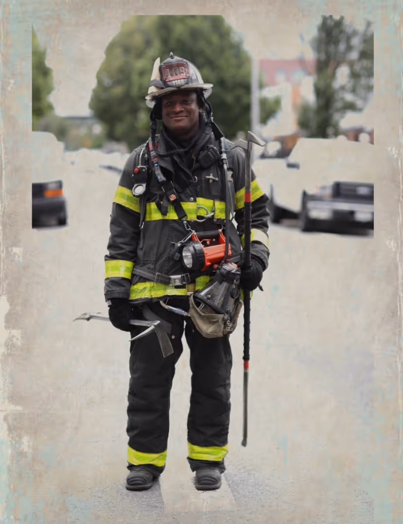 Thomas, the founder of M.O.S. Challenge Coins, standing in full firefighter gear