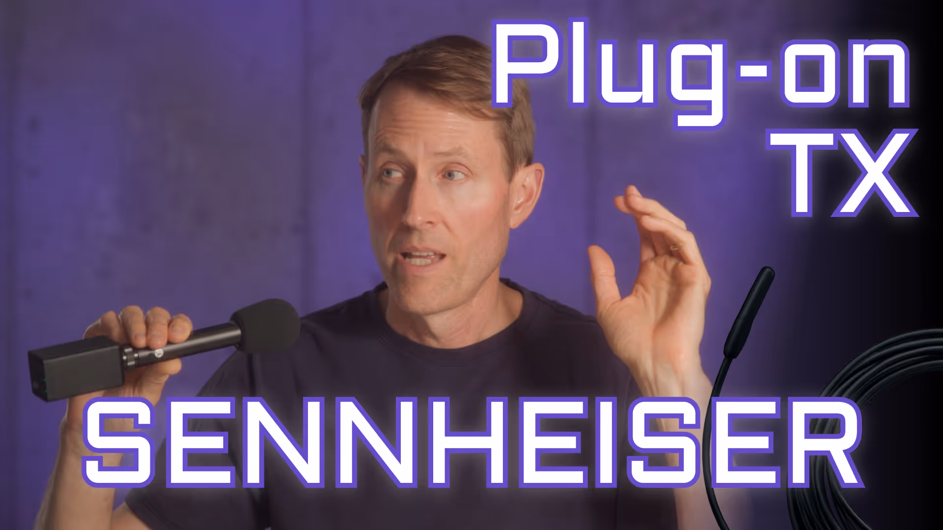 Curtis Judd holding a microphone with a wireless transmitter attached to its output port