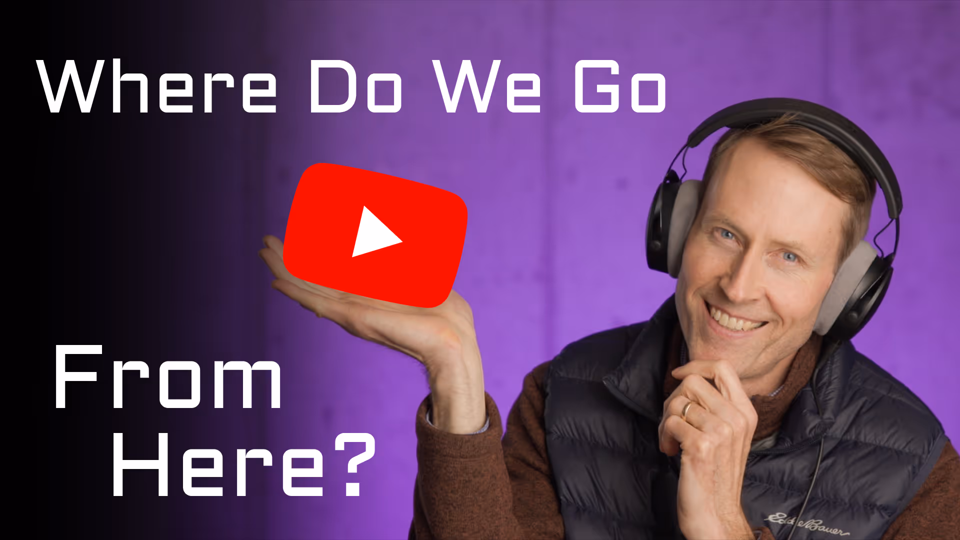 Curtis holds the YouTube logo at a jaunty and slightly mischievous angle...