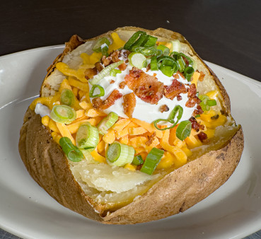 A guacamole burger with bacon.