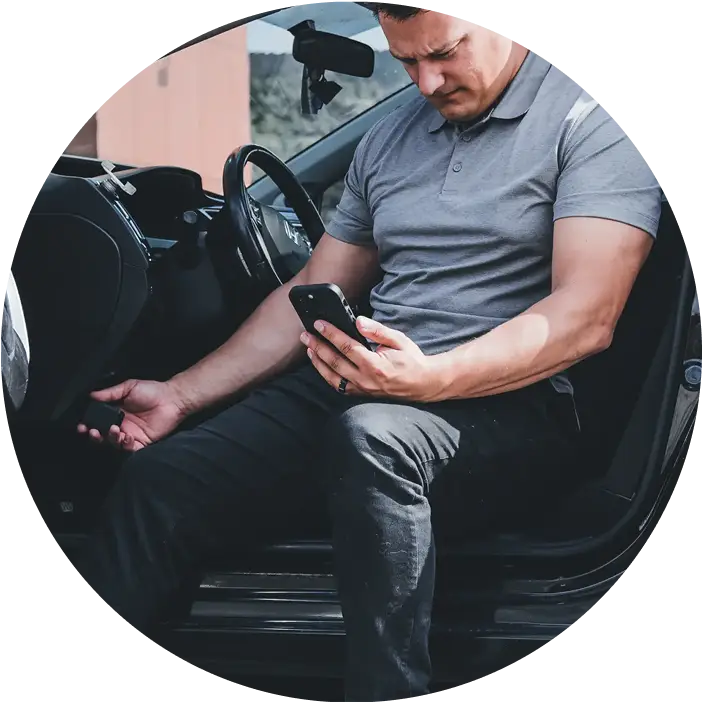 Man looking at his phone while using the BlueDriver MAX tool.