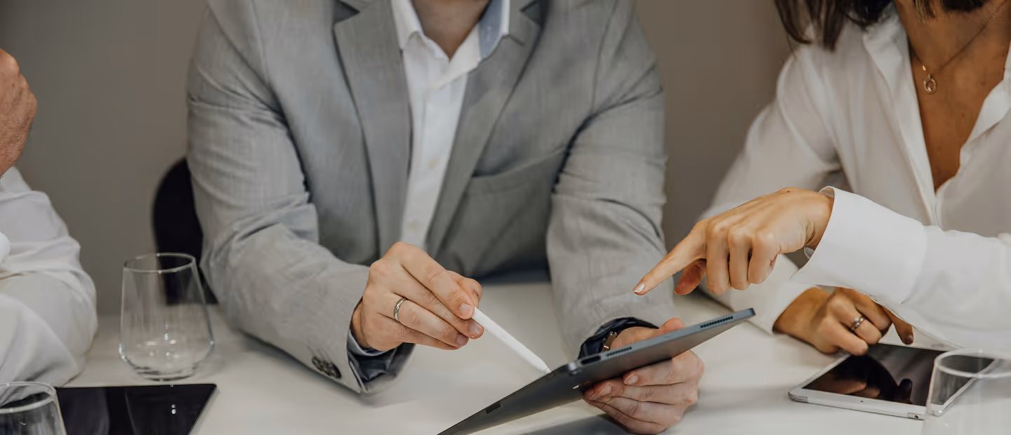 2 People pointing at a tablet