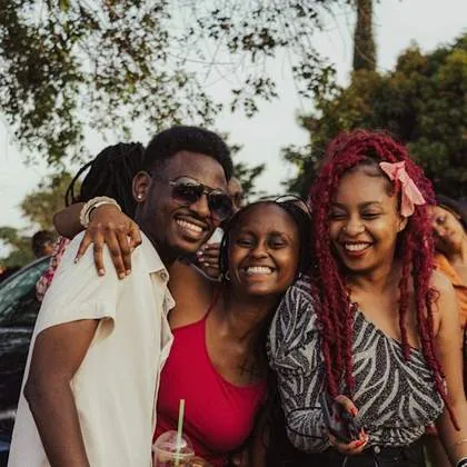 Three friends hugging and laughing
