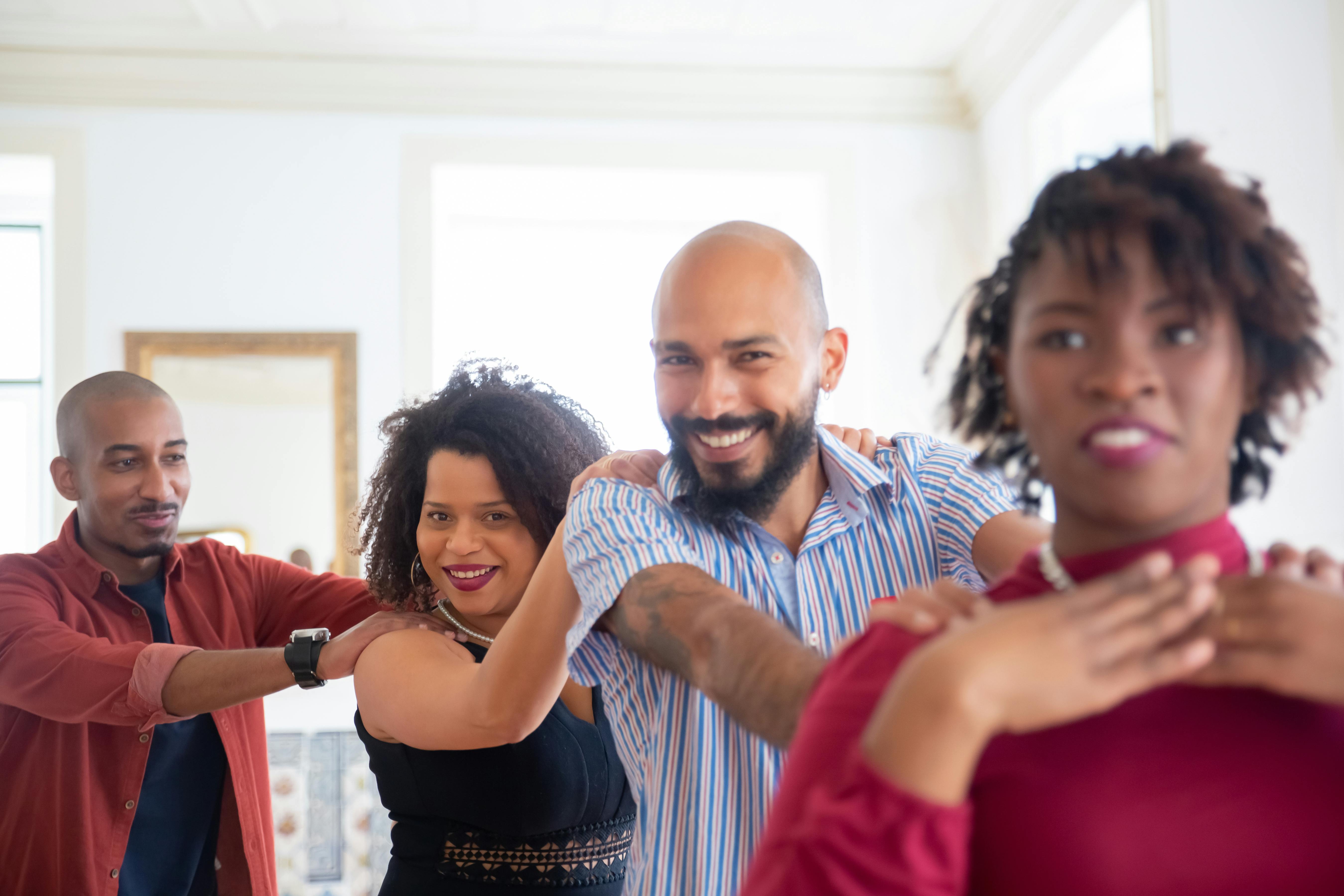 A group of adults smiling and dancing in a line, demonstrating a fun line dancing activity—highlighting how people in Australia connect through local dance events and partners.