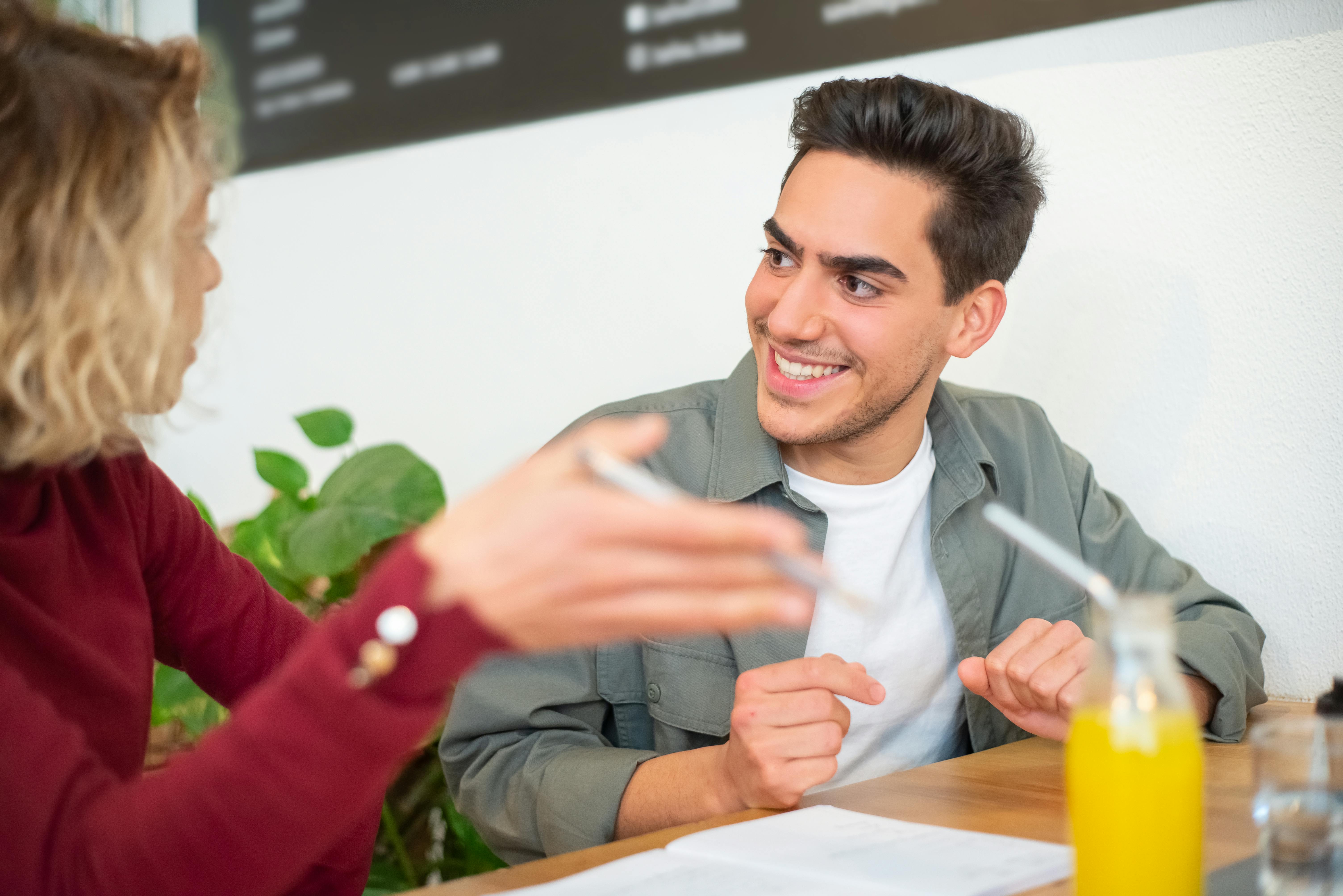 Man and woman chatting and smiling during a casual in-person meetup
