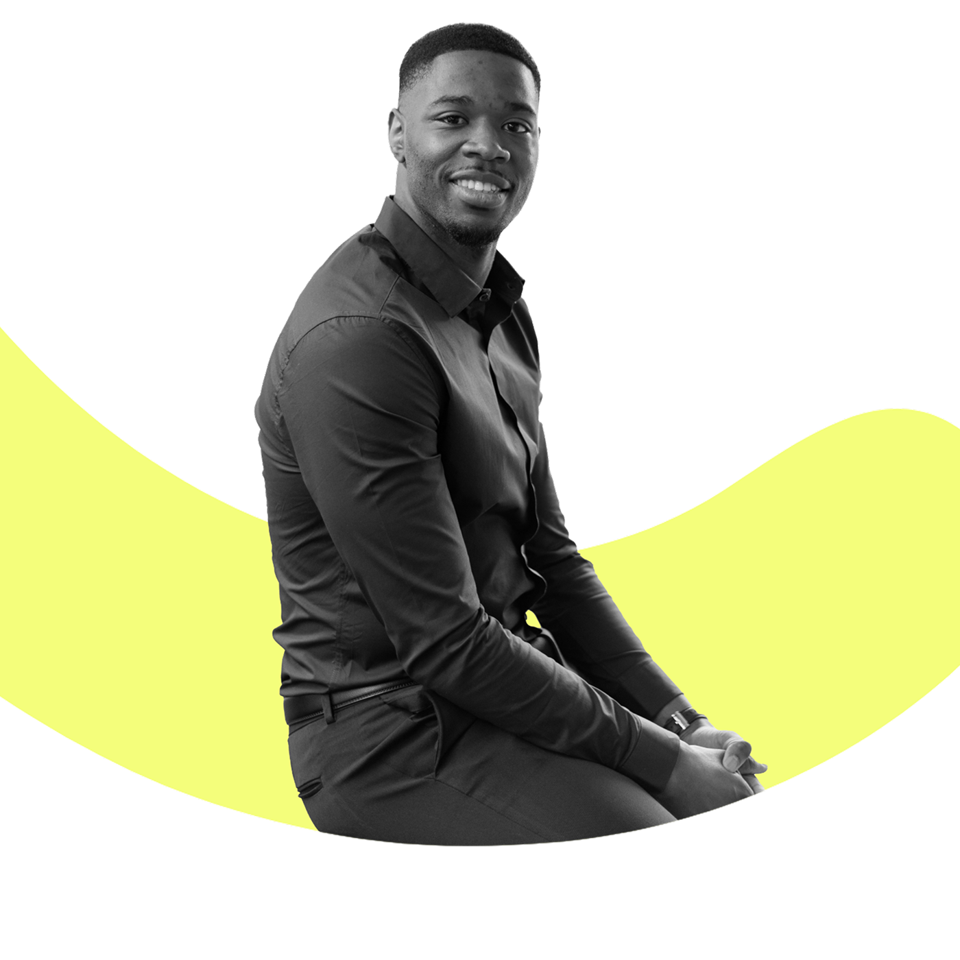 Smiling man in a black shirt sitting with hands clasped against a yellow wavy background.