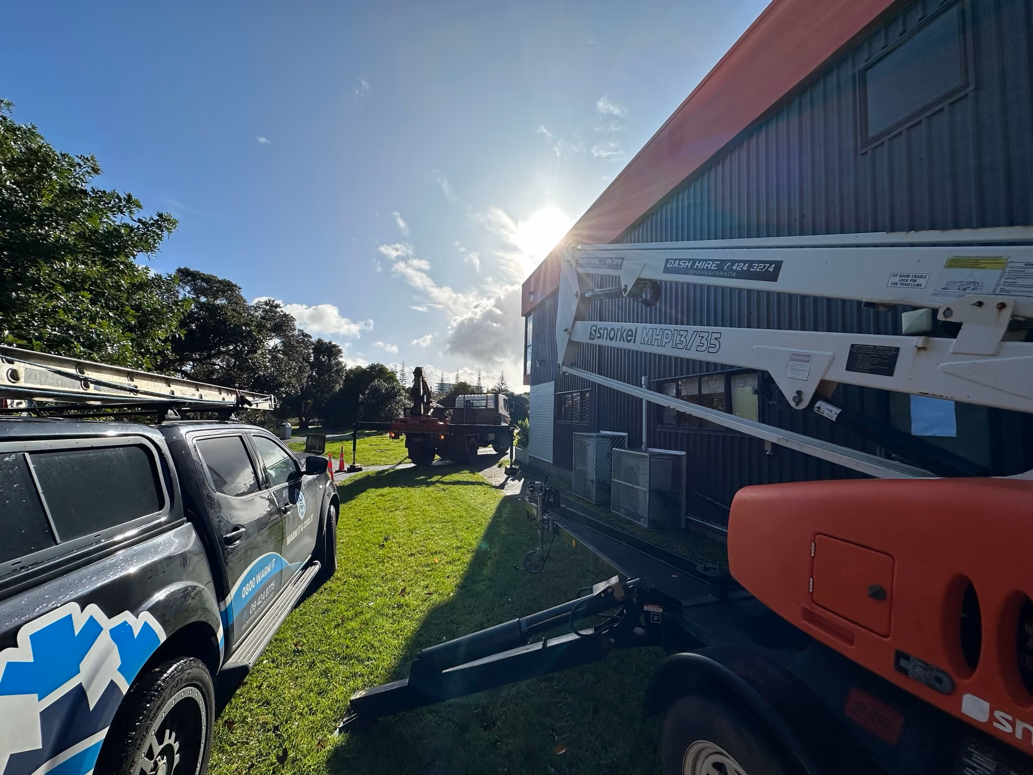 Warm It & Cool It vehicle and access equipment at a commercial air conditioning project