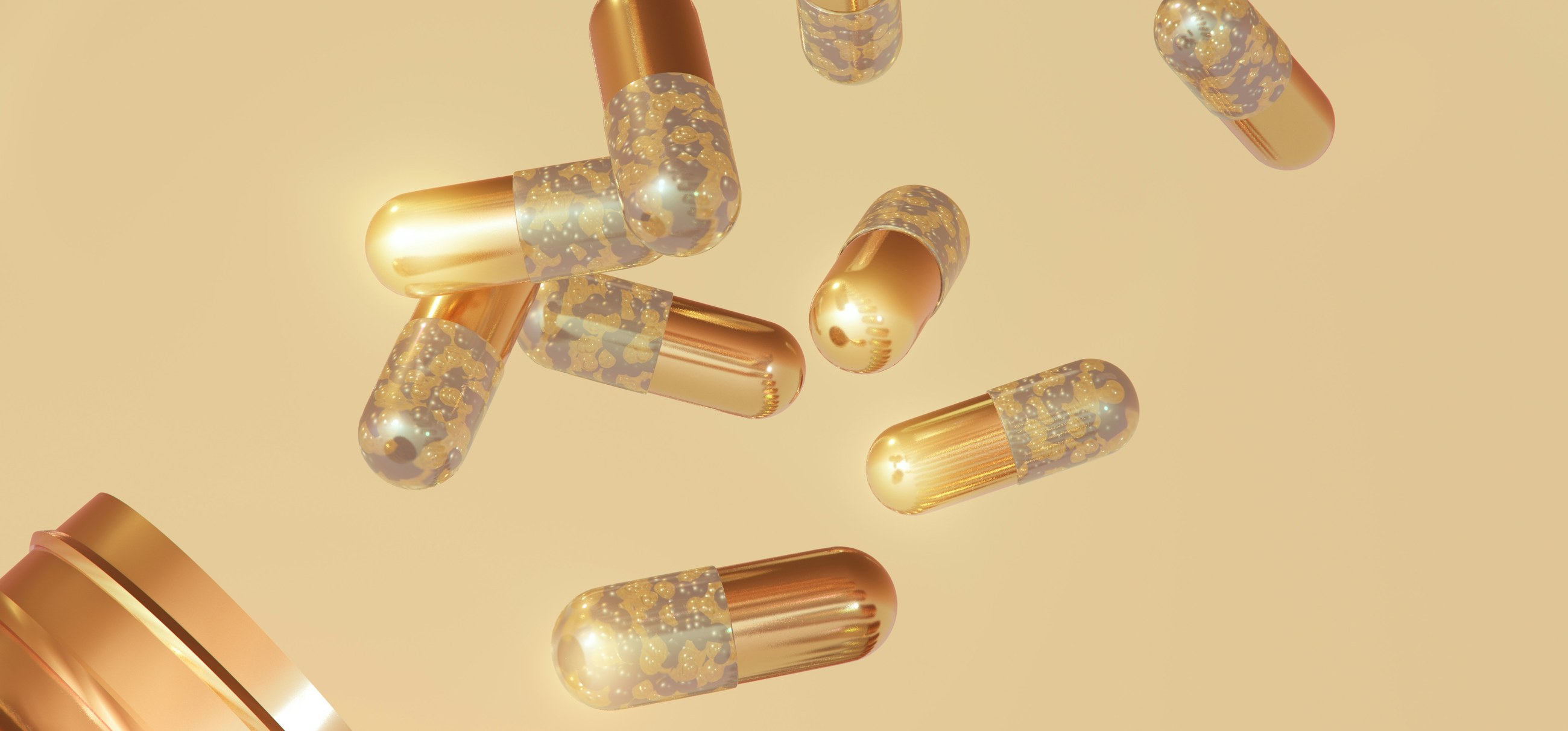Gold supplement capsules floating above an open jar
