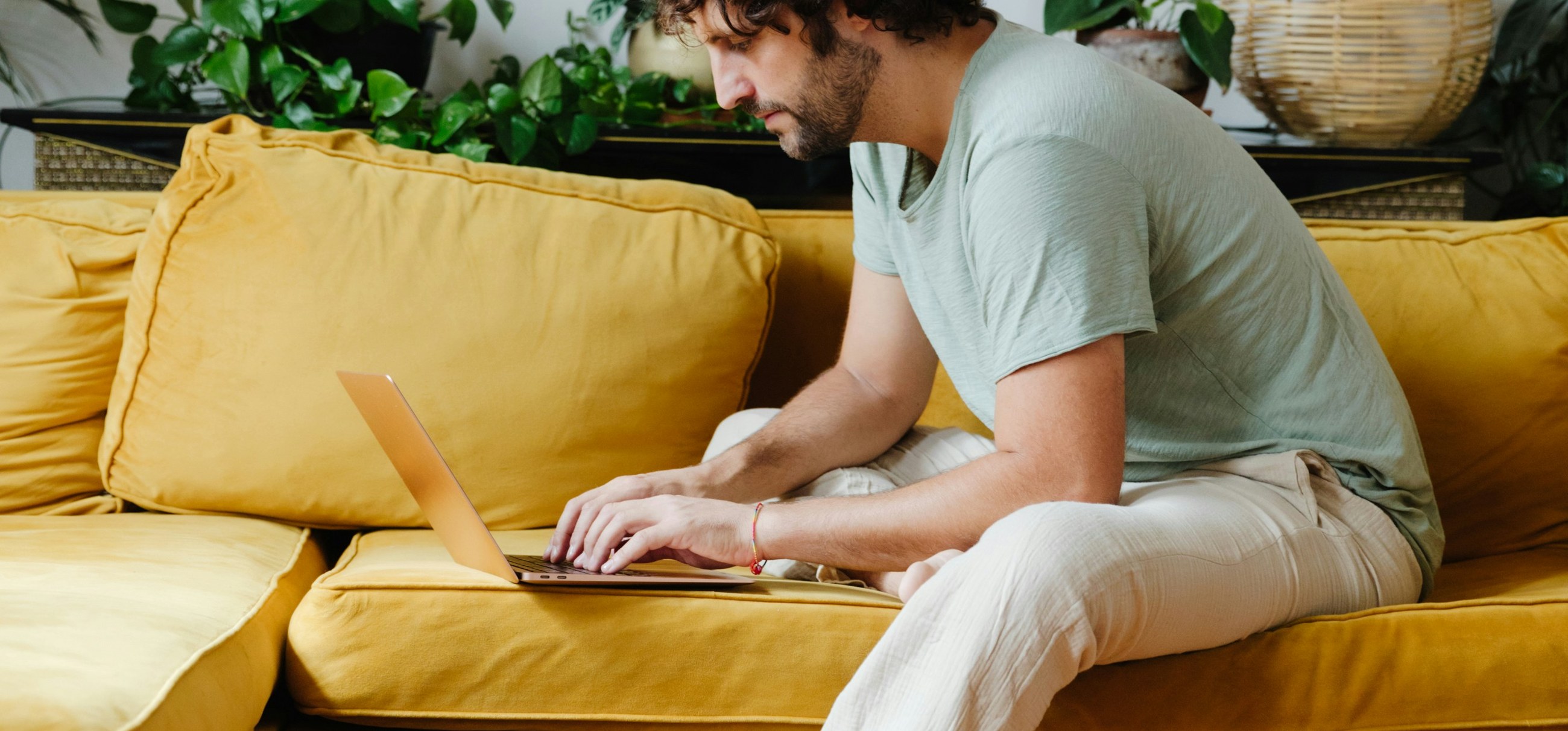 A man booking an appointment on a laptop at home