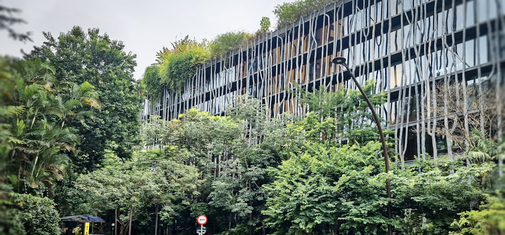 A long modern building with planting along its facade