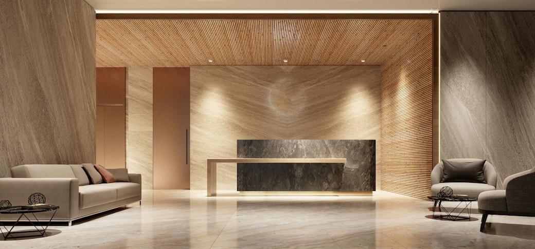 A premium reception with a stone desk and wood panelling