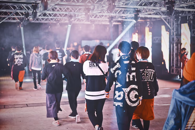 image of a music festival with vibrant colorful smoke