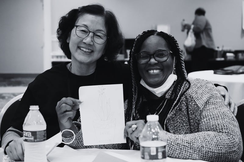 Two participants at the LA convening with their drawing
