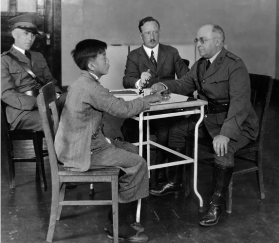 Image: Immigration interview on Angel Island, 1923 (National Archives))