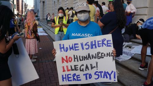 Community members protesting the termination of Temporary Protected Status
