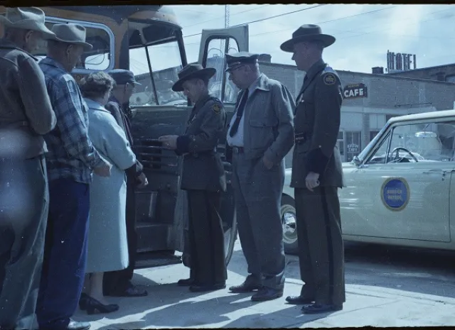 Border patrol agents checking a bus