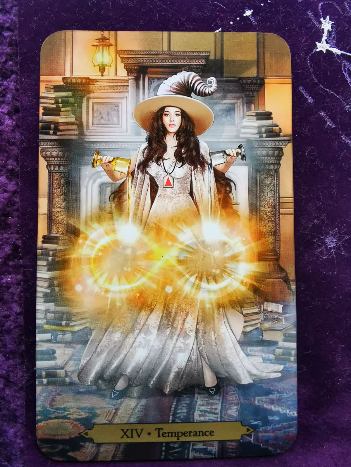 Temperance card from the Wizards Tarot showing a female wizard blending energies with chalices and an infinity symbol.