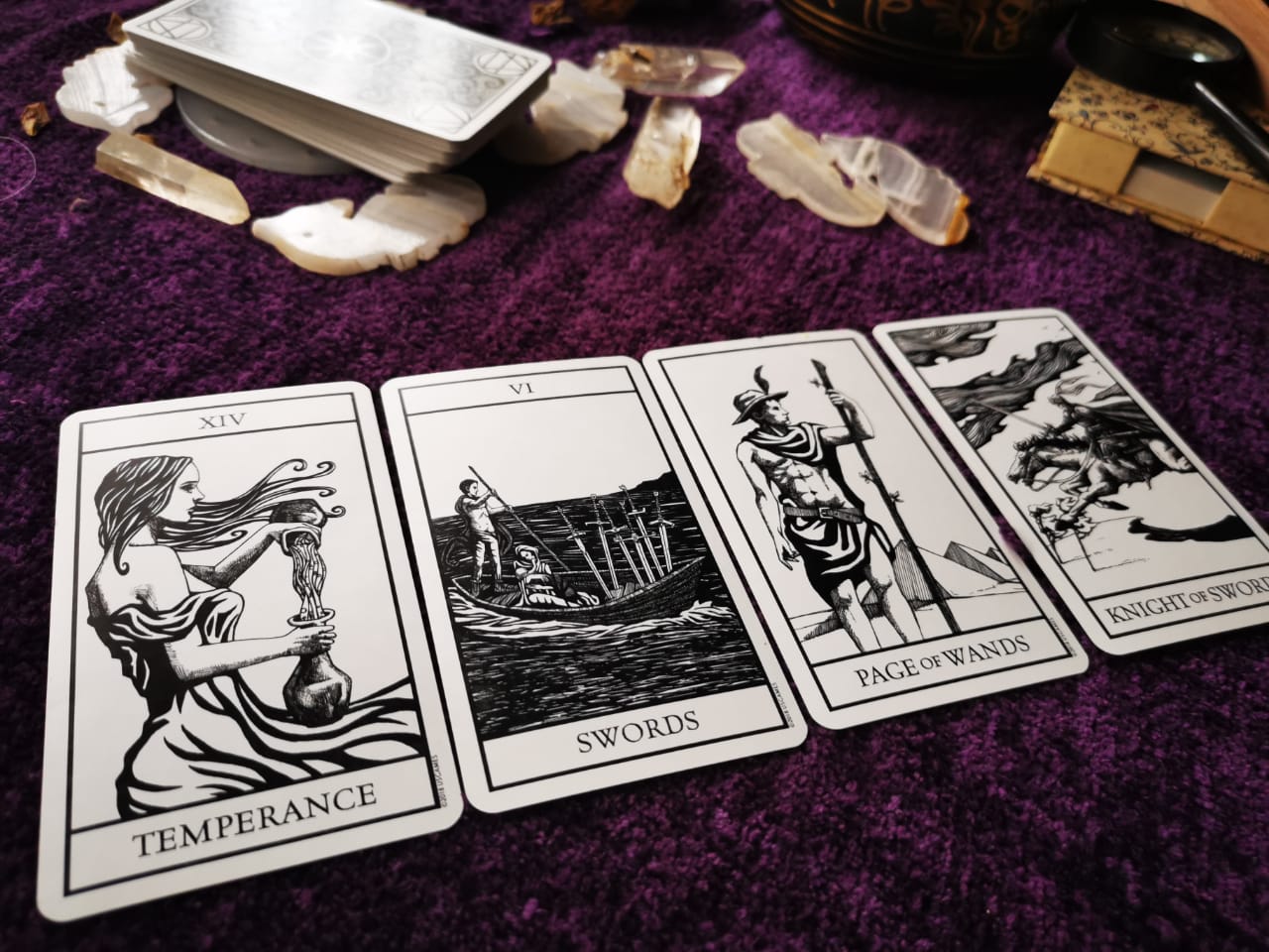 Bianco Nero tarot deck arranged in a sacred Wiccan reading setup with black and white symbolic cards.