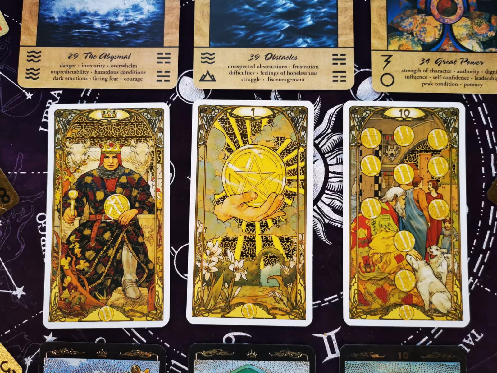 Tarot spread with the King, Ace, and Ten of Pentacles from Art Nouveau Tarot, symbolizing wealth, beginnings, and legacy.