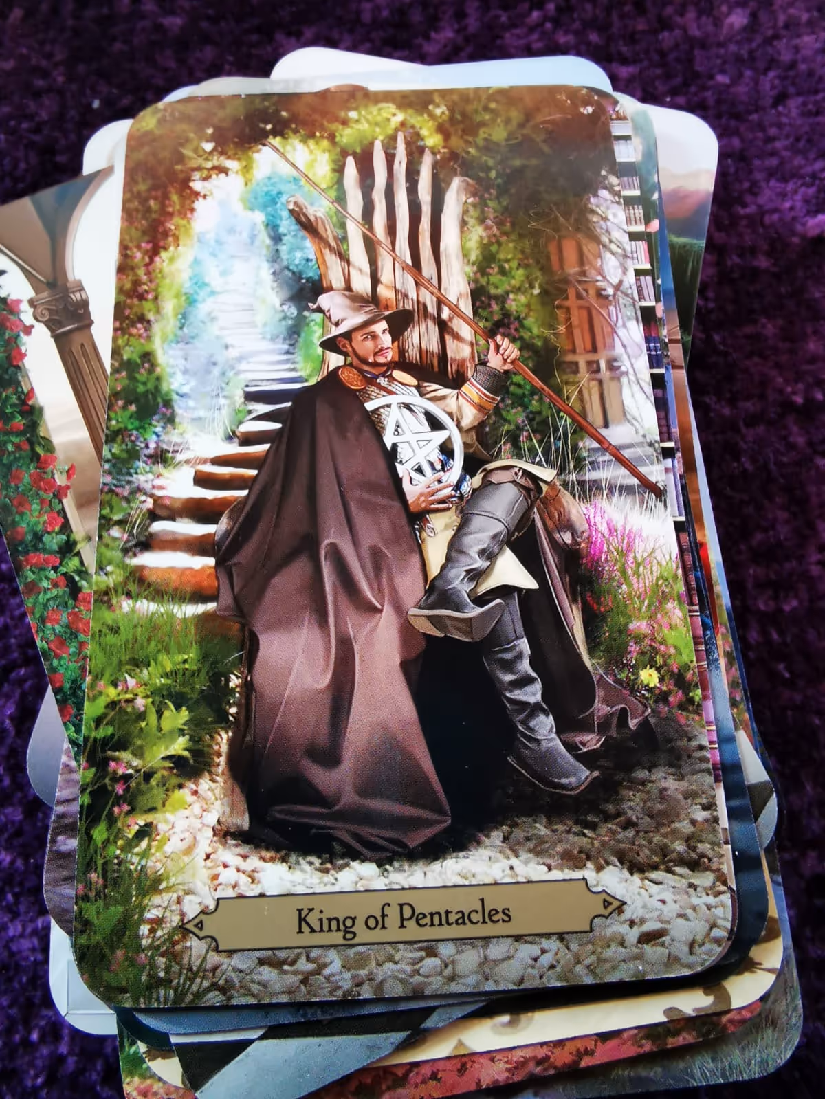 The King of Pentacles card from the Wizards Tarot, representing stability, mastery, and magical abundance.