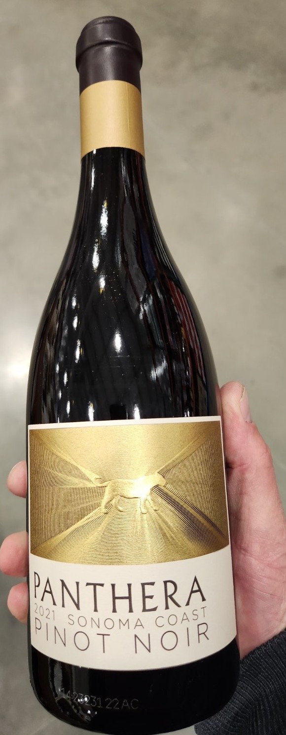 Bottle of Hess Panthera 2021 Sonoma Coast Pinot Noir held in hand at a wine shop.