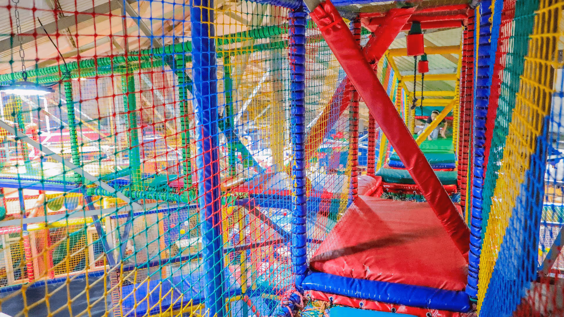 Colorful indoor children's playground with interconnected netted play structure