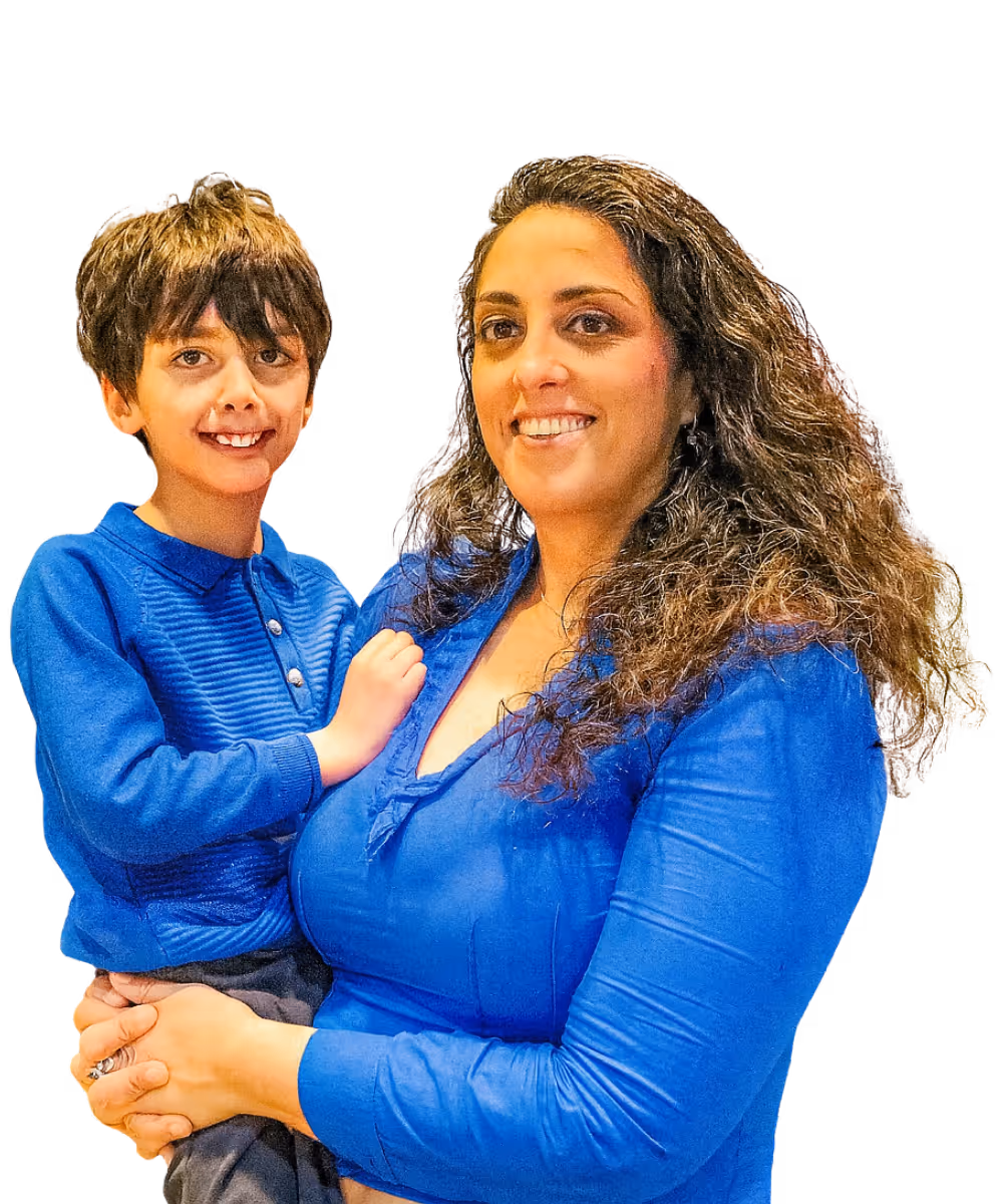 Smiling woman holding young boy in matching blue shirts