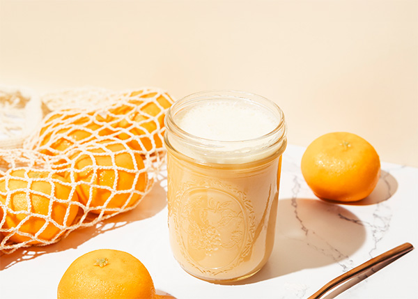 A delicious orange creamsicle meal shake and some oranges