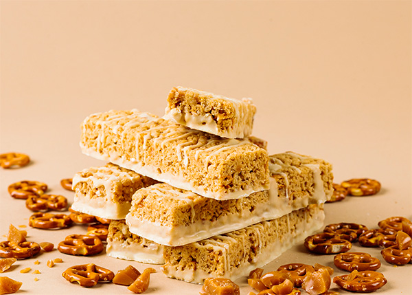 A pile of delicious protein salted toffee pretzel snack bars.