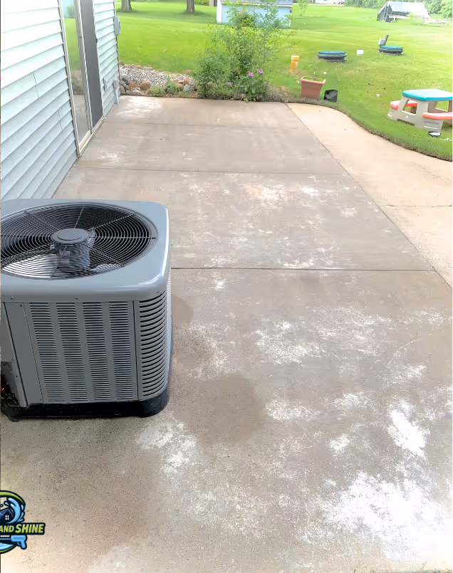 Concrete patio with patches of dirt and moss, after Splash and Shine cleaning