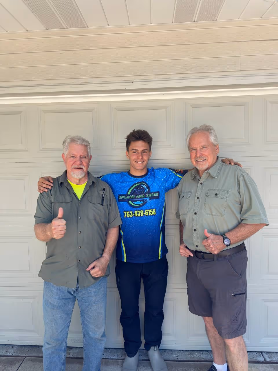 Splash & Shine Pressure Washing team with happy homeowner after service