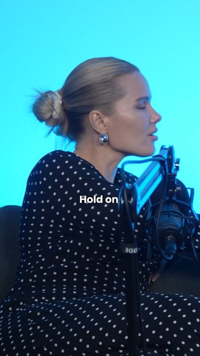 Video ad: a creator talking to camera on a podcast set, captioned Hold on
