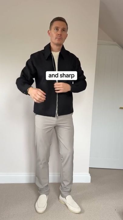 Video ad: a man showing an outfit of a black jacket and light trousers, captioned and sharp