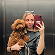 An image of girl with a dog smiling to camera