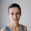 An image of smiling woman, she's a yoga teacher in studio in Krakow, Poland